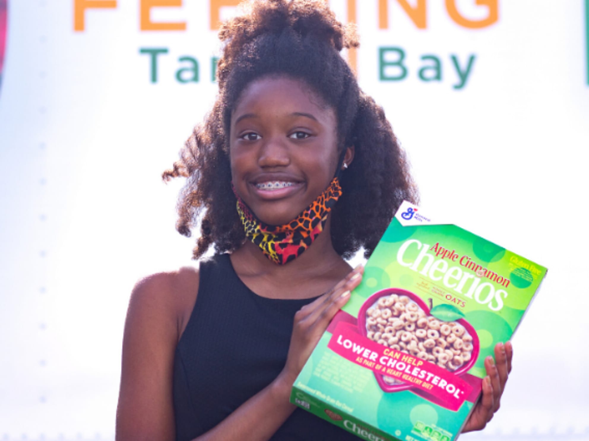 Kennedy McCormick holding box of Cheerios